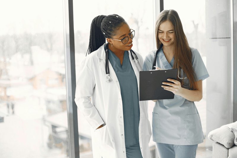 two medical professionals reviewing a chart