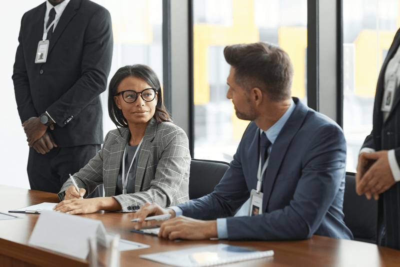 Two professionals at conference room table