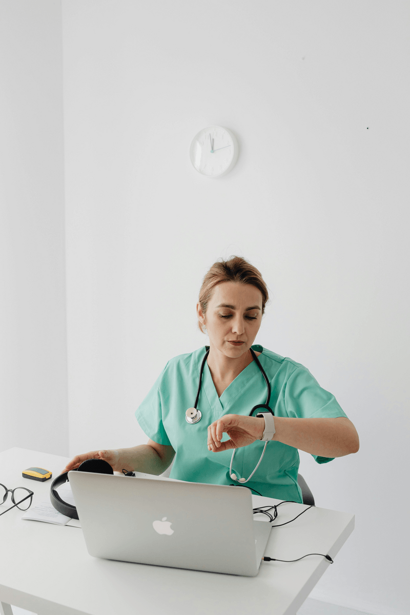 a medical professional checking her watch