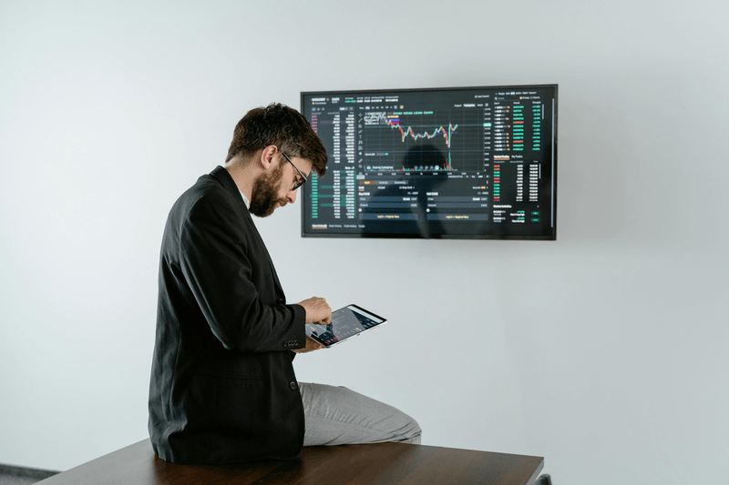 Man in an office room looking at tablet