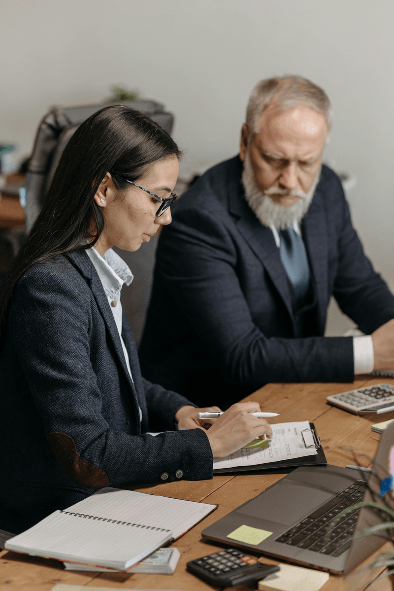 man and woman looking at laptop