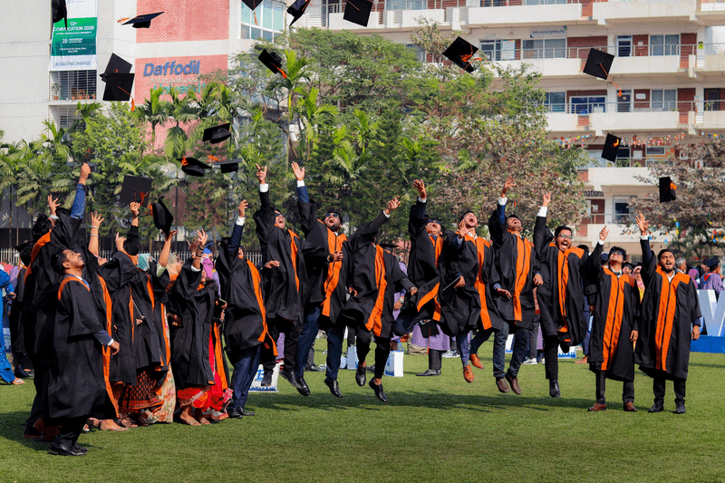graduates throwing their caps in the air
